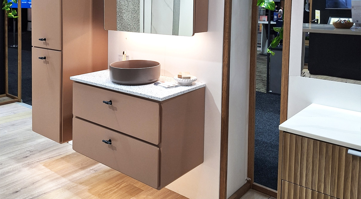 Colby 900mm wall hung vanity in New Penny Satin, paired with a Lapis Salt SilkSurface top and a Taupe Matte Allure Ceramic basin. Featuring Black Duke T Bar handles and under cabinet lighting. Finished with a matching Colby shaving cabinet and tallboy.
