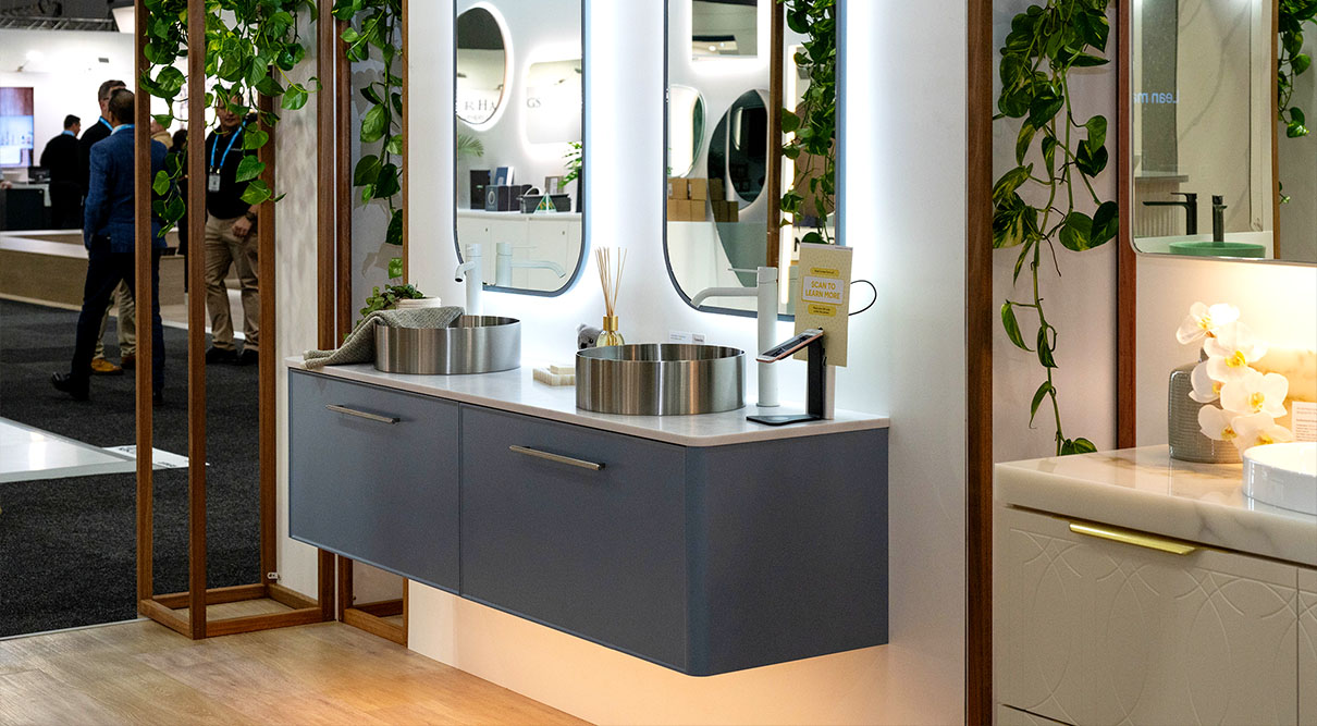 Saba 1800mm double bowl wall hung vanity in Saxby Blue Satin with Kent routed front. Paired with a Carrara SilkSurface top and Brushed Nickel Luxe Stainless Steel basins. Featuring Brushed Nickel 340mm Monarch handles and Under Cabinet Lighting. Finished with Jazz Arch Frame 630 mirrors with Around Mirror Lighting, and Nero Mecca tall basin mixers.